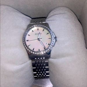 Gucci watch with diamond bezel and mother of pearl